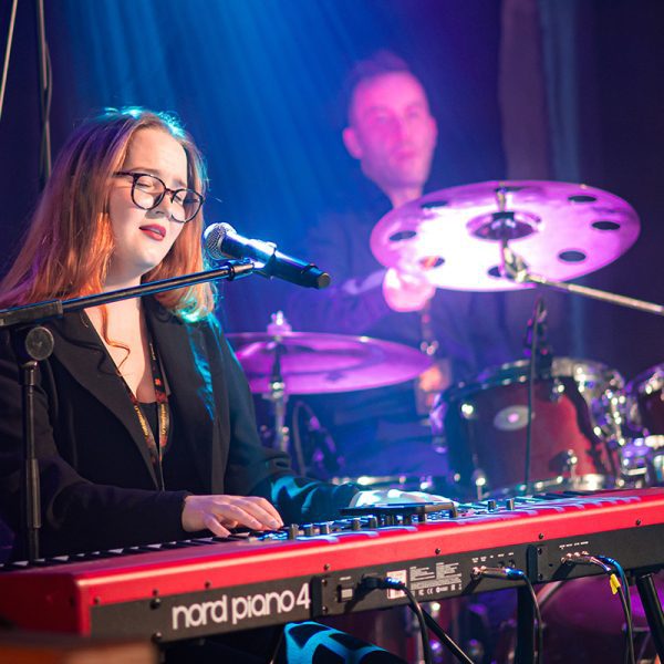 Matilda Nikkinen laulaa ja soittaa koskettimia, taustalla rumpali